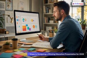 Man designing colorful education presentation slides on computer at desk with notes and sticky pads in office