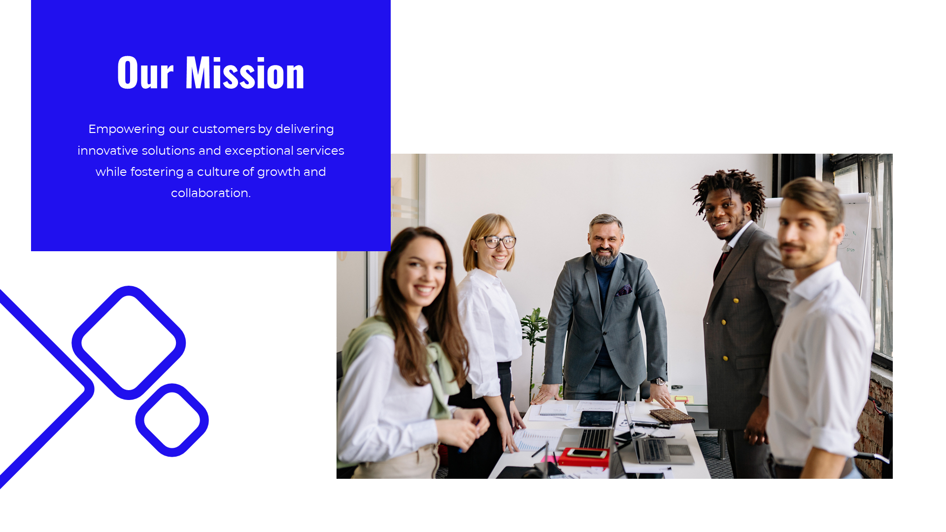 Five colleagues smiling and standing in an office, surrounded by laptops, with blue geometric shapes on the left.