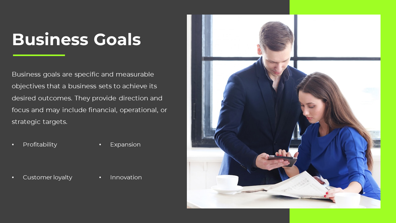 Business professionals discuss objectives with a smartphone, with a slide listing business goals in dark grey and green.