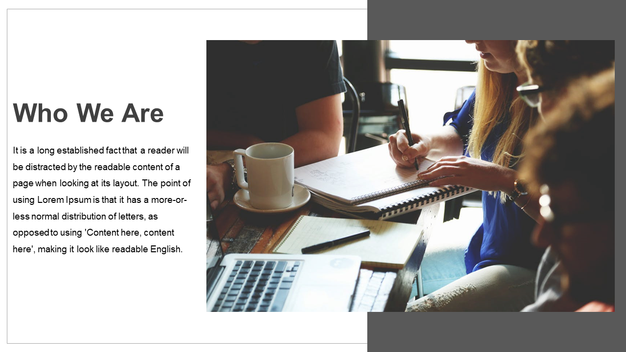 Slide featuring a photo of people working together at a table with laptops, paired with text, using gray and white tones.