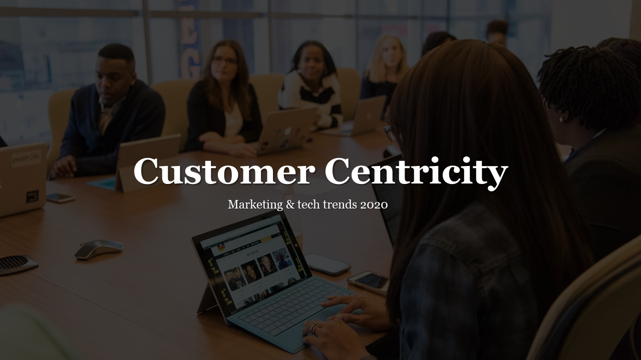 Group of people in a meeting around a table with laptops, overlaid with bold white text on customer centricity.