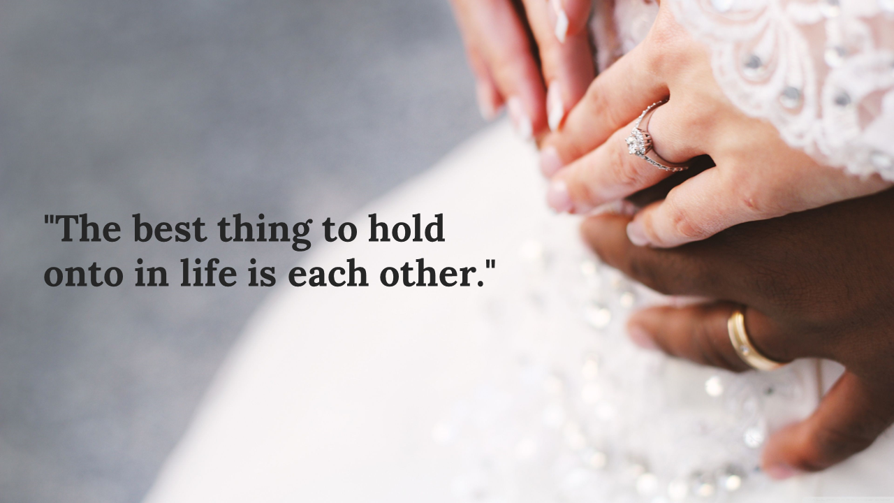 Close up of hands holding each other, with wedding rings visible, featuring a romantic quote.