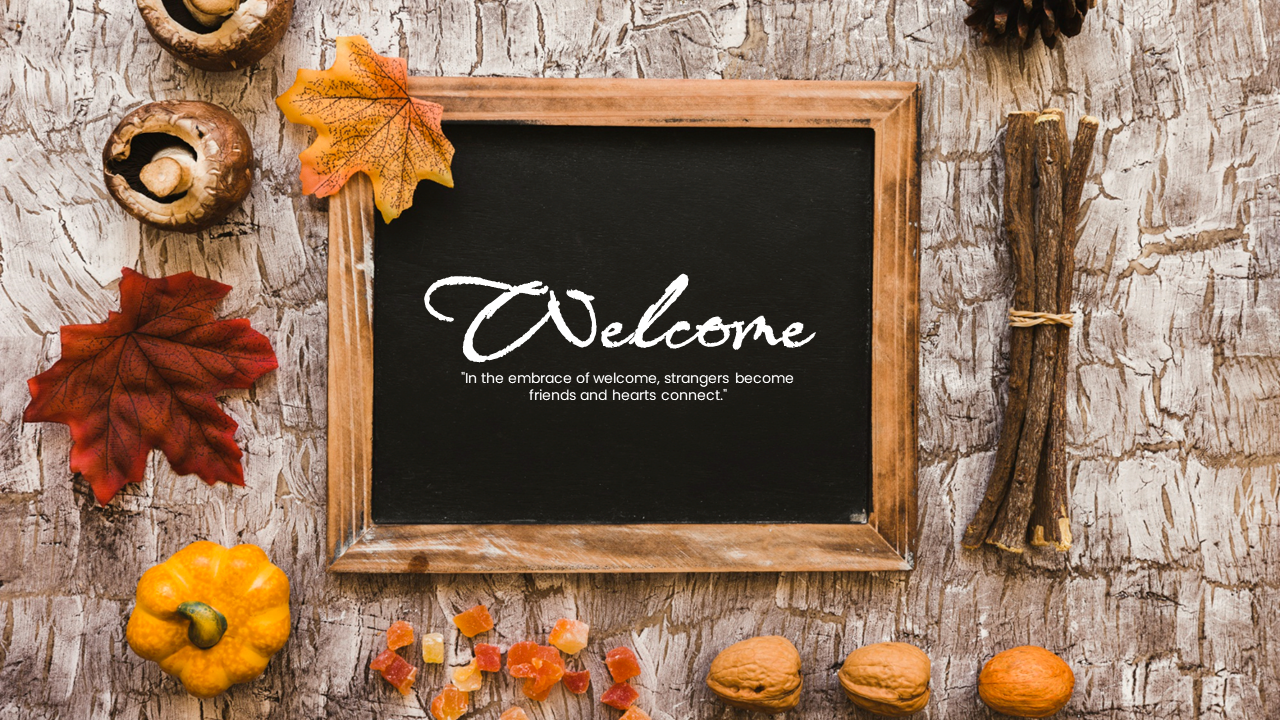 A Welcome message on a chalkboard, surrounded by autumn leaves, pumpkins, and sticks, with a quote.