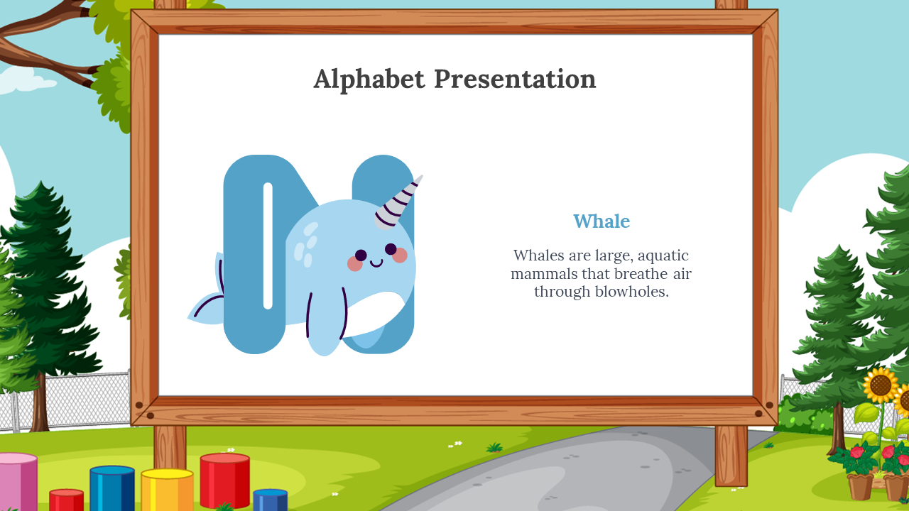 Light blue N with a cartoon whale in front, placed on a wooden framed whiteboard, with outdoor playground and trees behind.