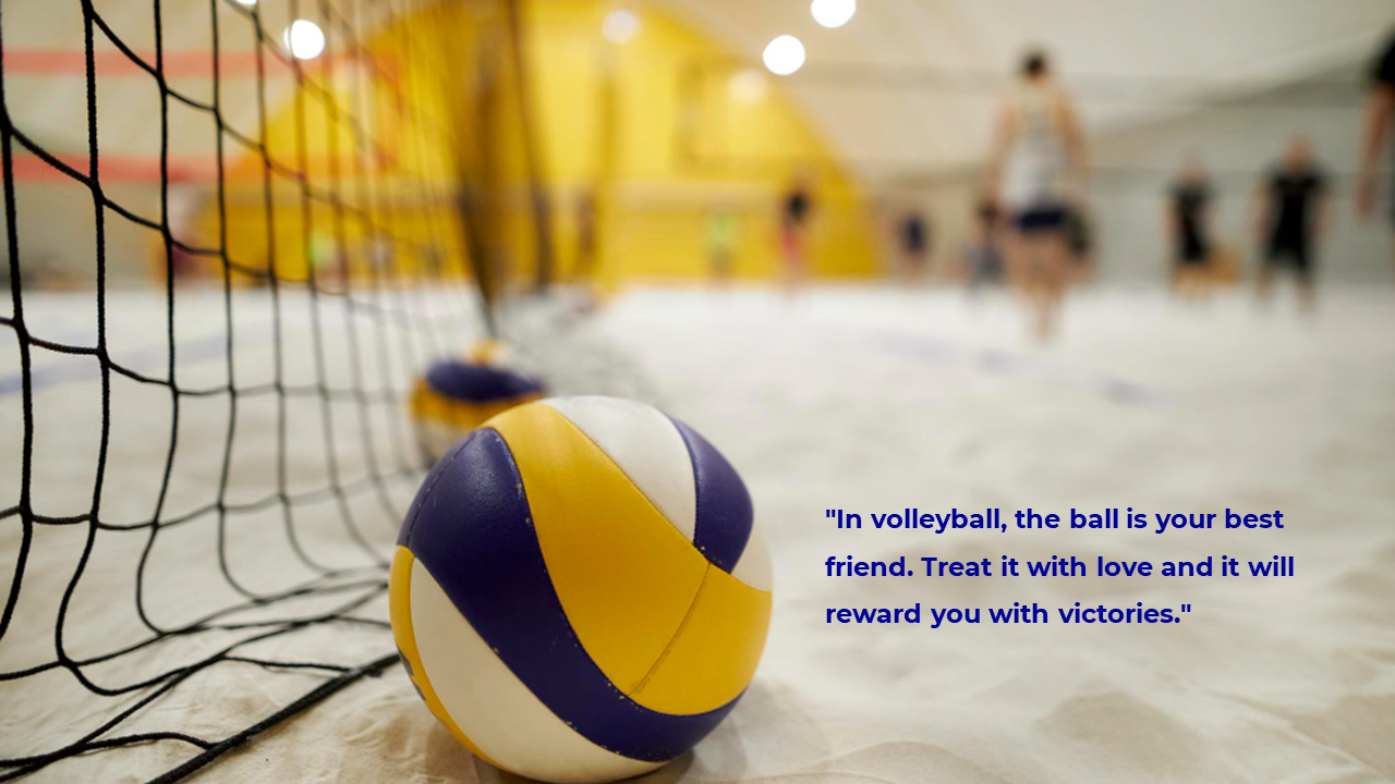 Volleyball on indoor sand court beside net with blurred players in background and quote text at lower right.