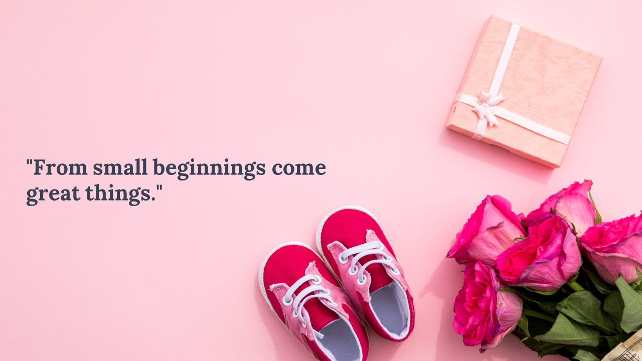 Flat lay with pink baby sneakers, bouquet of roses, and a gift box beside a quote on a pastel pink background.