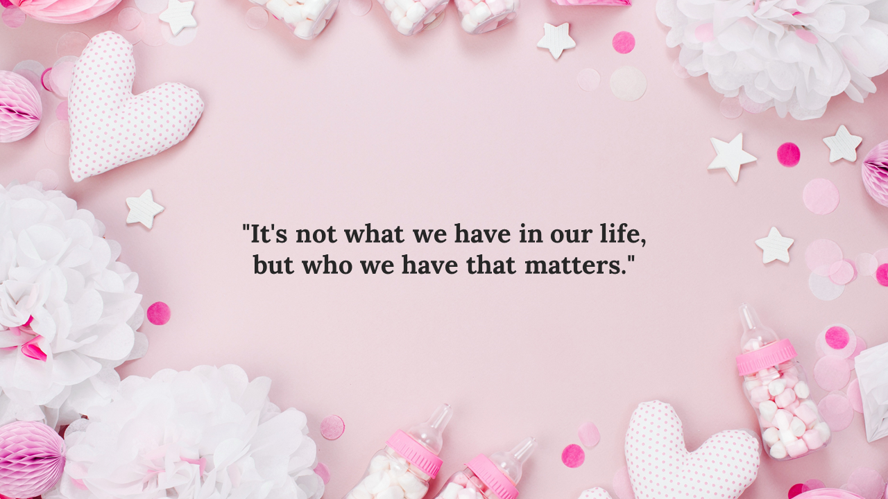 Pastel pink flat lay with white tissue flowers, polka dot hearts, candy bottles, confetti, and an inspirational baby quote.