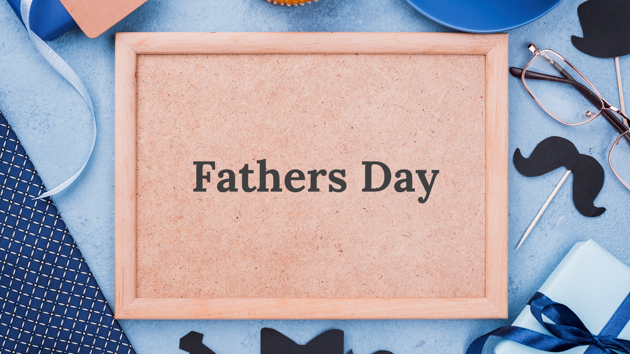 Framed corkboard with fathers Day text, surrounded by men’s accessories, wrapped gift, and mustache decorations.