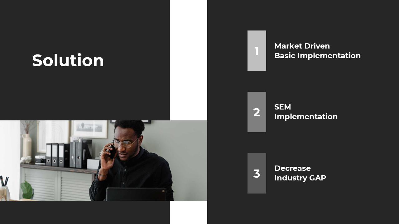A person on the phone in an office setting, discussing solutions with documents, and a laptop in the background.