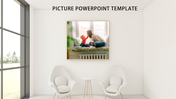Picture template showing a cozy framed photo above modern white chairs and table in a bright, window lit room.