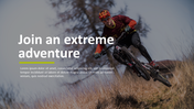 A mountain biker in red and black gear descends a grassy slope with blurred trees in the background on a clear day.