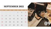 September 2022 calendar PPT template with a gift wrapped package and decorations, with the 9th day highlighted.
