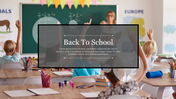 Back to school slide showing a teacher at the chalkboard and children with raised hands, with title text in a dark box.