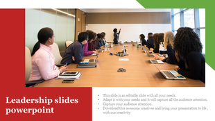 Meeting room with a diverse team seated around a wooden table, and a presenter at the whiteboard, with red and green accents.