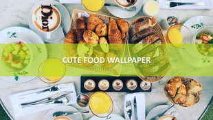 Assorted food items like pastries, bread, fruit bowls, and coffee arranged neatly on a round marble table.