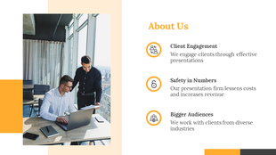 About us slide with an image of two men working at a laptop, featuring yellow highlights, and descriptive text.
