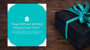 Teal themed birthday card with a cake illustration and a message, set against a gift box with a ribbon, on a wooden surface.