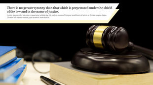 A gavel resting on a sound block with law books and a pen in the background symbolizes justice and legal authority.