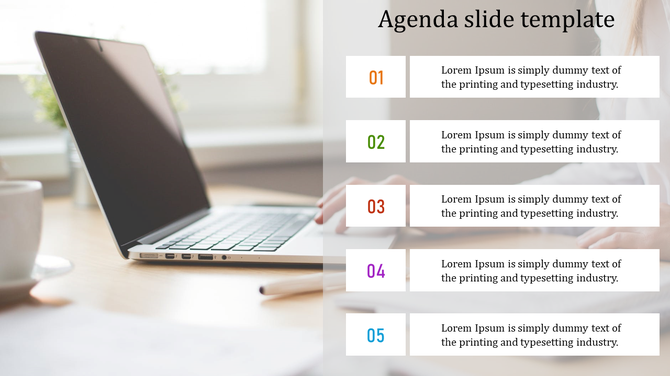 Slide showing a list of five agenda points with a blurred workspace and laptop in the background.