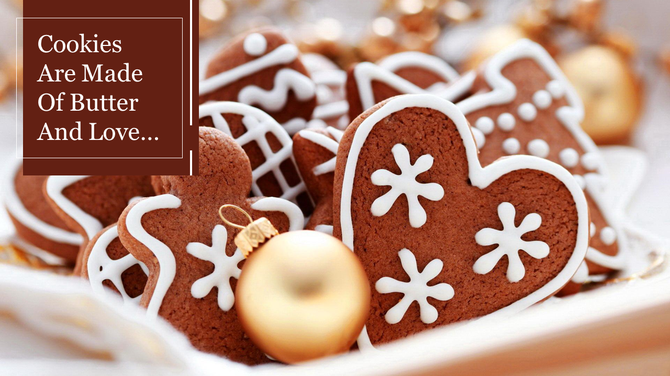 Christmas cookies with intricate white icing patterns surrounded by golden baubles and festive decorations.